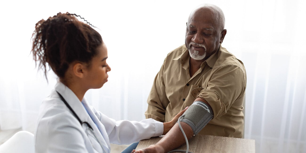 A provider taking a patient's blood pressure